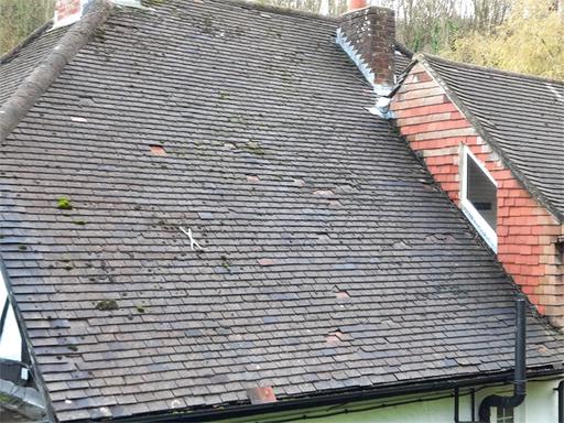 A dilapidated tiled roof covering